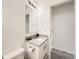 Clean bathroom featuring a vanity with a sink, mirror and toilet at 4987 N Walden Way, Denver, CO 80249