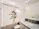 Bathroom featuring a vanity with a sink and a shower with a curtain at 4987 N Walden Way, Denver, CO 80249