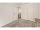 This bedroom features neutral paint, grey carpet, and an adjacent hallway, offering a blank slate for personalization at 4987 N Walden Way, Denver, CO 80249