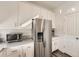 Stainless steel refrigerator and white cabinets fill this bright and clean kitchen at 4987 N Walden Way, Denver, CO 80249