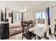 Bright living room and dining area with large sliding glass doors to let the outside in at 4987 N Walden Way, Denver, CO 80249