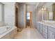 Luxurious primary bathroom featuring double vanity, soaking tub and walk-in shower, perfect for relaxation at 1967 Haystack Rd, Castle Rock, CO 80104