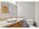 Cozy bathroom with decorative mirror, updated fixtures, and tile counter adding a touch of style at 1967 Haystack Rd, Castle Rock, CO 80104
