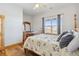 Comfortable bedroom features a four-poster bed, wood trim, and a window with stunning views at 1967 Haystack Rd, Castle Rock, CO 80104