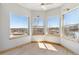 Bright bedroom with large windows, offering panoramic views of the surrounding landscape and plenty of natural light at 1967 Haystack Rd, Castle Rock, CO 80104