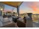 Relaxing deck area with outdoor seating, a fire pit, and scenic views at sunset at 1967 Haystack Rd, Castle Rock, CO 80104