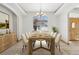 Charming dining room featuring a modern chandelier, large view window, and wooden table at 1967 Haystack Rd, Castle Rock, CO 80104