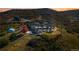 Luxurious home featuring a swimming pool, sprawling landscape, and breathtaking mountain views at sunset at 1967 Haystack Rd, Castle Rock, CO 80104