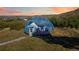 Unique geodesic dome home exterior with a door and greenery, sitting on a lush, sloping lot at 1967 Haystack Rd, Castle Rock, CO 80104