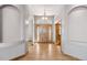 Elegant foyer features arched doorways, hardwood floors, and a beautiful wood front door with leaded glass at 1967 Haystack Rd, Castle Rock, CO 80104