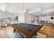 Bright game room featuring a billiard table, bar seating, recessed lighting, and natural light from scenic outdoor views at 1967 Haystack Rd, Castle Rock, CO 80104