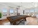 Spacious game room showcasing a billiard table, tray ceiling, recessed lights, large windows, and scenic outdoor vistas at 1967 Haystack Rd, Castle Rock, CO 80104