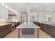 Open kitchen features a marble center island, stainless steel appliances, and custom cabinetry at 1967 Haystack Rd, Castle Rock, CO 80104