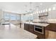 Spacious kitchen boasts white marble countertops, stainless appliances, and abundant natural light at 1967 Haystack Rd, Castle Rock, CO 80104