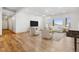 Bright living room features hardwood floors, white walls, large windows with mountain views, and comfortable neutral-toned seating at 1967 Haystack Rd, Castle Rock, CO 80104
