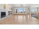 Spacious living room featuring a fireplace, large windows, hardwood floors, and balcony access at 1967 Haystack Rd, Castle Rock, CO 80104
