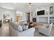 Bright living room features a fireplace, ceiling fan, hardwood floors, and views of the entryway at 1967 Haystack Rd, Castle Rock, CO 80104