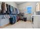 Large walk-in closet with custom shelving and laundry hookups providing ample storage space and convenience at 1967 Haystack Rd, Castle Rock, CO 80104