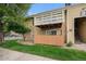 Exterior shot of a tan home with a private balcony on well-manicured lawn at 10251 W 44Th Ave # 3-204, Wheat Ridge, CO 80033