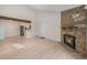 Open-concept living space featuring a stone fireplace, hardwood floors and updated kitchen at 10251 W 44Th Ave # 3-204, Wheat Ridge, CO 80033