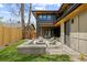Grassy backyard featuring a modern outdoor living space with a fire pit and stylish seating at 1100 S Elizabeth St, Denver, CO 80210
