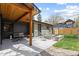 Relaxing backyard with a covered patio, comfortable seating, and a built-in fire pit area at 1100 S Elizabeth St, Denver, CO 80210
