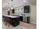 Finished basement bar area with modern fixtures, cabinetry, and barstool seating at 1100 S Elizabeth St, Denver, CO 80210