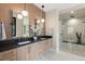 Modern bathroom featuring dual sinks, sleek countertops, and a luxurious glass-enclosed shower at 1100 S Elizabeth St, Denver, CO 80210