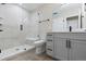 Modern bathroom featuring a glass-enclosed shower with bench and a sleek vanity with dark hardware at 1100 S Elizabeth St, Denver, CO 80210