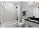 Modern bathroom with white subway tile shower, soaking tub and black fixtures at 1100 S Elizabeth St, Denver, CO 80210