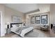 Serene bedroom with natural light, neutral decor, and comfortable seating area at 1100 S Elizabeth St, Denver, CO 80210