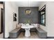 Cozy dining nook with built-in seating, unique pendant lighting, and decorative paneling at 1100 S Elizabeth St, Denver, CO 80210