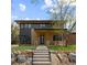 Modern home with a well-manicured lawn, natural stone accents, and a welcoming covered porch at 1100 S Elizabeth St, Denver, CO 80210