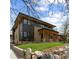 Contemporary home boasts a blend of dark and light exteriors and a lush lawn at 1100 S Elizabeth St, Denver, CO 80210