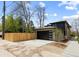 Modern home featuring an attached garage with a sleek black door and ample driveway space on a sunny day at 1100 S Elizabeth St, Denver, CO 80210