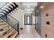 Hallway with modern staircase, wood accents, and plenty of natural light at 1100 S Elizabeth St, Denver, CO 80210