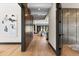 Hallway featuring wood paneling, modern doors, and access to living areas at 1100 S Elizabeth St, Denver, CO 80210
