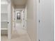 Well-lit hallway with neutral walls and carpeting, showcasing access to various rooms at 1100 S Elizabeth St, Denver, CO 80210