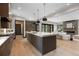 Open concept kitchen with a center island, modern appliances, and seamless flow into the living area at 1100 S Elizabeth St, Denver, CO 80210