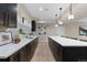 Modern kitchen features a long island with pendant lighting, white countertops, and dark cabinetry at 1100 S Elizabeth St, Denver, CO 80210