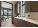 Kitchen with marble countertops and backsplash, brass hardware, and custom cabinetry at 1100 S Elizabeth St, Denver, CO 80210