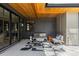 Stylish outdoor patio area with comfortable seating, modern decor, and a wood paneled ceiling at 1100 S Elizabeth St, Denver, CO 80210