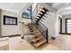 Modern staircase with open wood treads, black metal railing, and glass partition offers contemporary appeal at 1100 S Elizabeth St, Denver, CO 80210
