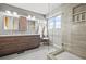 Modern bathroom featuring a dual sink vanity, large mirror, and tiled walk-in shower at 5211 E 116Th Ave, Thornton, CO 80233