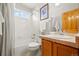 Bright bathroom with a tub-shower combination, tile flooring, and modern fixtures at 5211 E 116Th Ave, Thornton, CO 80233