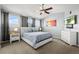 Light-filled bedroom with ceiling fan, large windows, modern furniture, and colorful wall art at 5211 E 116Th Ave, Thornton, CO 80233