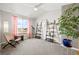 Bright bedroom features a telescope, two decorative ladders, and a cozy chair near a sunny window at 5211 E 116Th Ave, Thornton, CO 80233