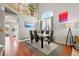 Elegant dining area featuring hardwood floors, soaring ceilings, and a modern light fixture at 5211 E 116Th Ave, Thornton, CO 80233