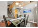 Dining area with a glass table set for six, a staircase to the second level, and hardwood floors at 5211 E 116Th Ave, Thornton, CO 80233