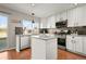 Bright kitchen featuring white cabinets, stainless steel appliances, and a center island at 5211 E 116Th Ave, Thornton, CO 80233